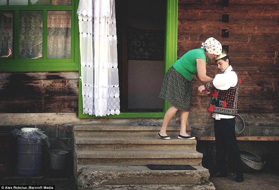 Here a mother prepares her son to go to a traditional festival in an outfit which would not have changed much in several generations
