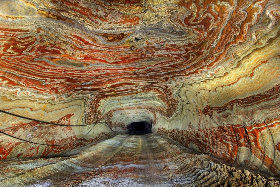 PIC BY MIKHAIL MISHAINIK / CATERS NEWS - (PICTURED The psychadelic walls inside the abandoned salt mine in Yekaterinburg, Russia) These psychedelic photographs give a rare glimpse inside the walls of an abandoned salt mine. After years of mining deep into the Earths crust, layers of a carnallite now line the tunnels with a spectacular mix of coloured rock. Used in the process of plant fertilisation, the mineral can appear in a variety of colours including white, red, yellow and blue. Although a small part of the mine is still in use, miles of tunnels now lay abandoned & are only accessible with a special government permit. SEE CATERS COPY **NOT FOR SALE / USE IN RUSSIA / POLAND**