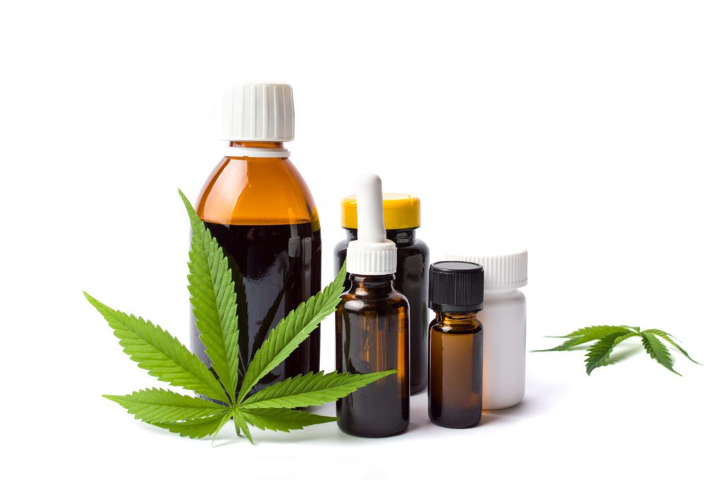 Marijuana plant and cannabis oil bottles isolated