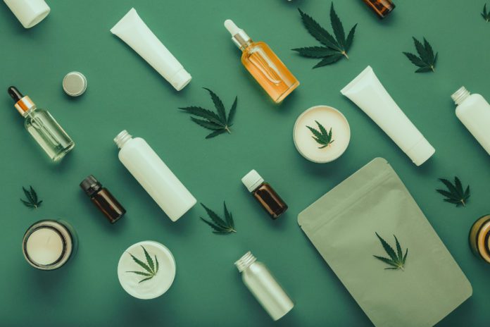 Hemp cbd oil serum in glass dropper bottle with cannabis leaves, Moisturizing cream, Serum, lotion, essential oil. Cannabis leaf with skincare cosmetic product Flat lay pattern on green background