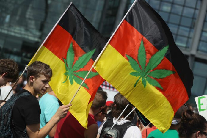 Activists, including two waving German flags that have a marijuana leaf painted on them, demanding the legalization of marijuana prepare to march in the annual Hemp Parade (Hanfparade) on August 13, 2016 in Berlin, Germany.